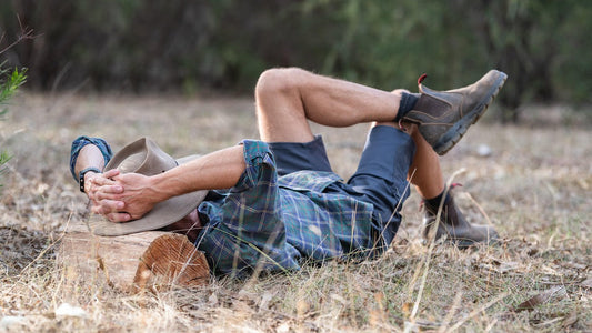 Man lying outdoors in nature, symbolizing healthy lifestyle and fertility wellness with focus on average sperm count by age.