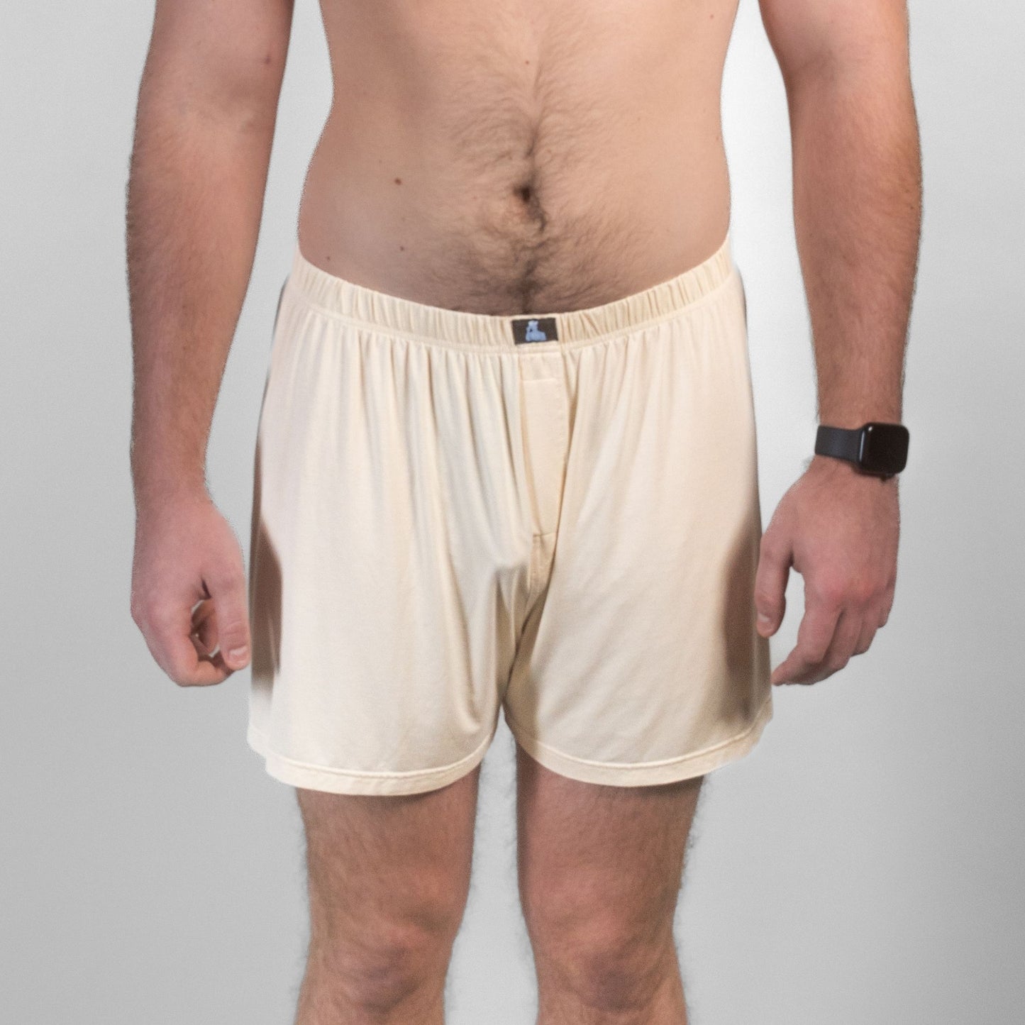 Front view of male model in beige Mr. Fertyl bamboo Lyocell boxers, showcasing breathable, non-toxic fertility-safe fabric.