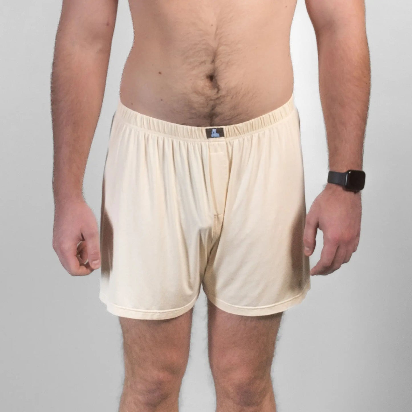 Front view of male model in beige Mr. Fertyl bamboo Lyocell boxers, showcasing breathable, non-toxic fertility-safe fabric.