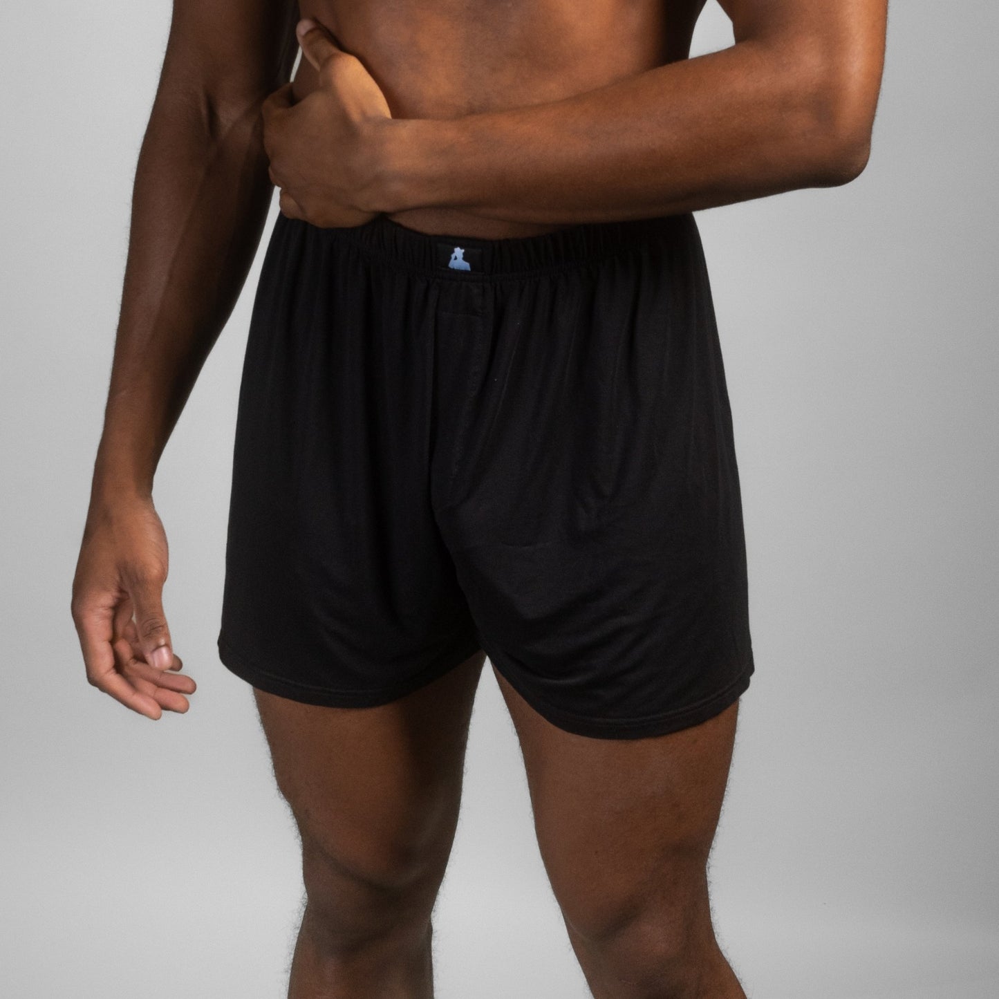 Male model posing in black Mr. Fertyl fertility-safe boxers, made from bamboo Lyocell for reproductive health and comfort.