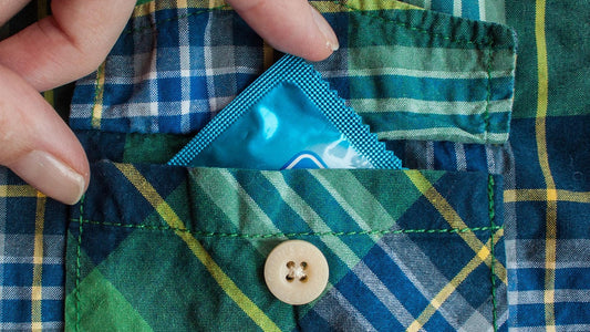 Natural or vegan condom in pocket, symbolizing mindful choices for fertility and reproductive health.