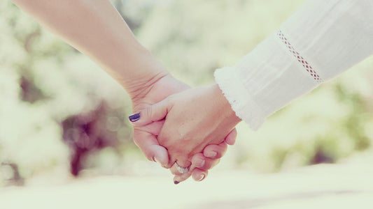Couple holding hands, symbolizing intimacy and connection while exploring if female orgasm increases conception chances.