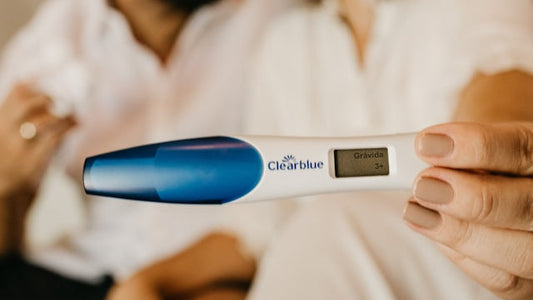 Couple holding positive pregnancy test during ovulation window, highlighting peak fertility and sperm quality importance.