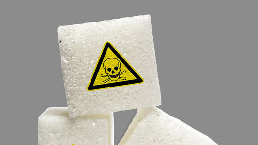 Sugar cubes stacked with toxic warning labels, symbolizing hidden chemicals in everyday products like clothing.