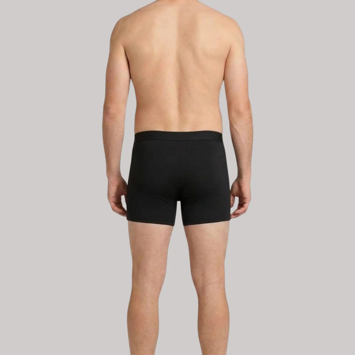 Back view of male model in black Mr. Fertyl Bamboo Lyocell boxer brief's, showcasing breathable, non-toxic fertility-safe fabric.