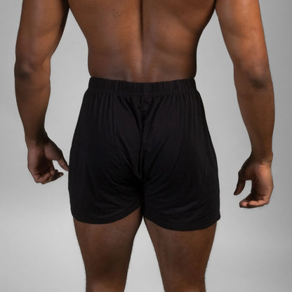 Rear view of male model wearing black Mr. Fertyl bamboo Lyocell boxers designed for breathability and fertility safety.