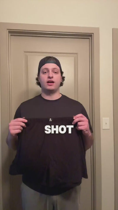 Young man in a backward cap holds black Mr. Fertyl boxer shorts while reviewing fertility-safe underwear in a UGC video.