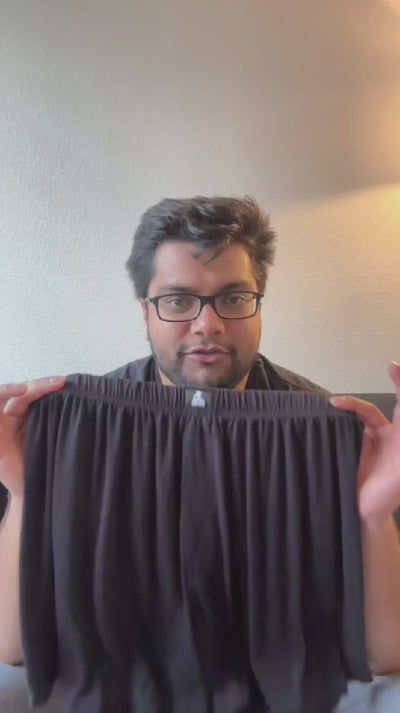 Man holding black Mr. Fertyl bamboo Lyocell boxer shorts, showcasing fertility-safe fabric in video testimonial.